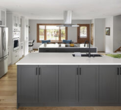 A main section of the countertop workspace in the New Brighton Upgrade renovation with grey lower cabinets and a white marble countertop.