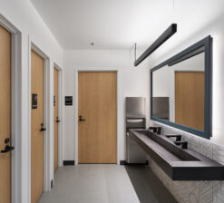 The accessible and gender neutral bathrooms with individual stalls and a shared sink at the Luminary Arts Center in Minneapolis, MN.