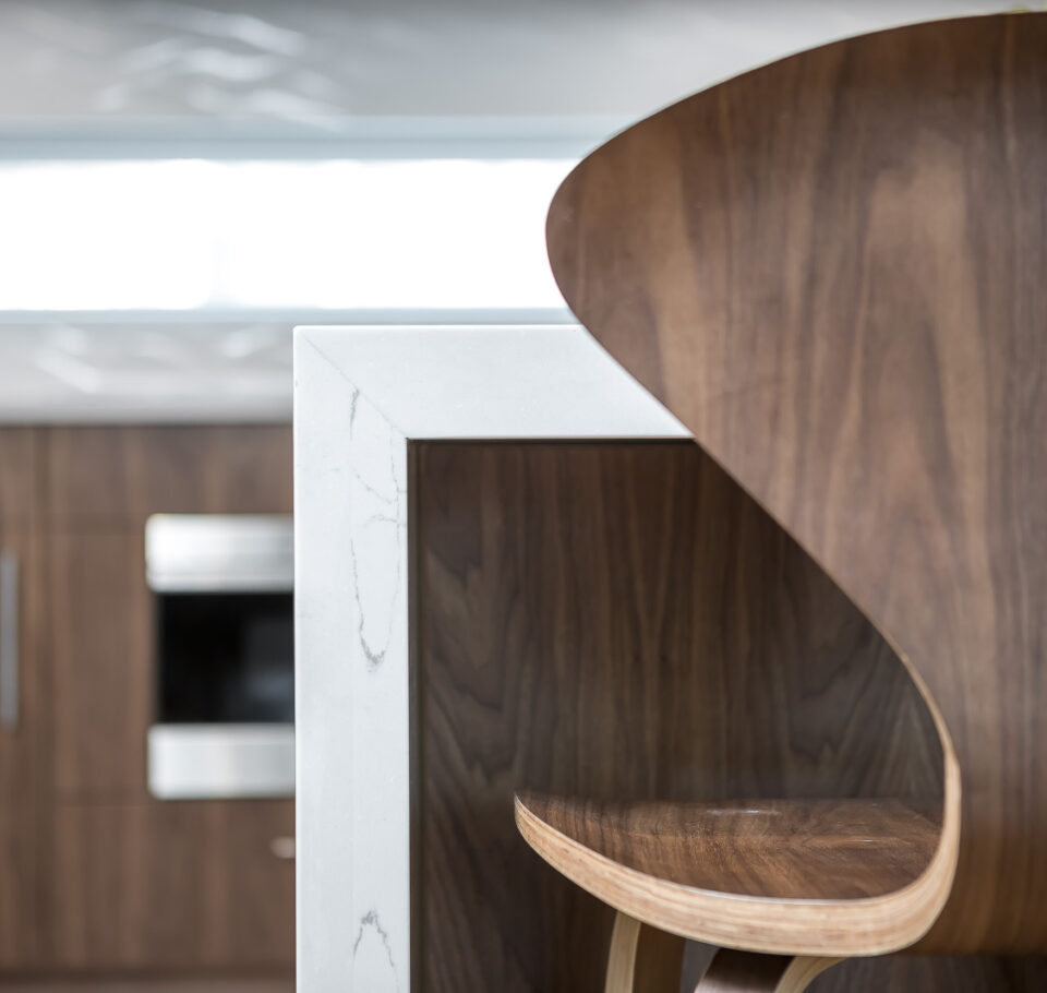 Barstool and island detail in the remodeled St. Louis Park Modern residence designed by Shelter Architecture + Interior Design.