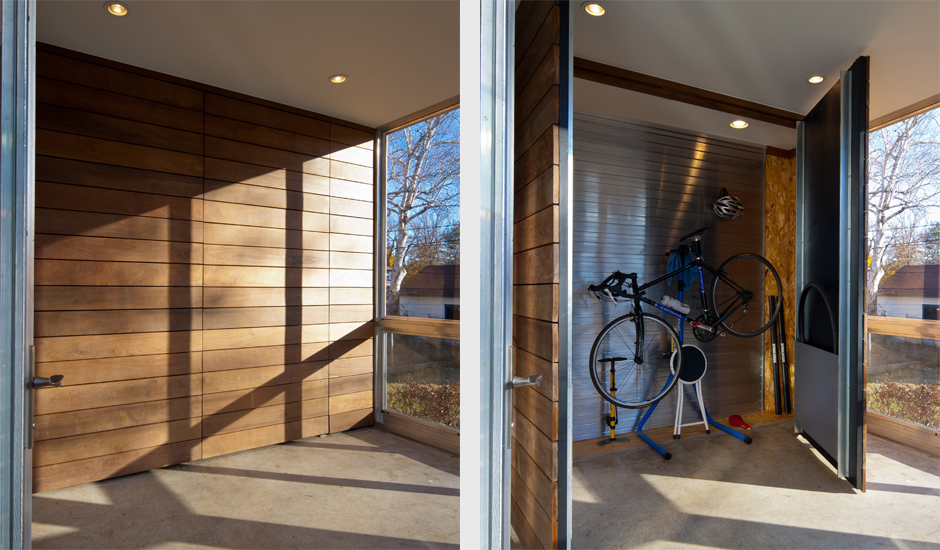 Wood paneled entryway of the renovated home. Hidden entryway closet doors open to show concealed bike storage.