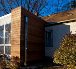 Side view of the exterior of the home surrounded by trees