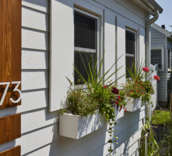 Two flower boxes below windows on the exterior of the Saint Paul Bungalow remodel.